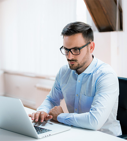 Property manager looking at laptop for risks against revenue and how to identify and maintain it during uncertain times